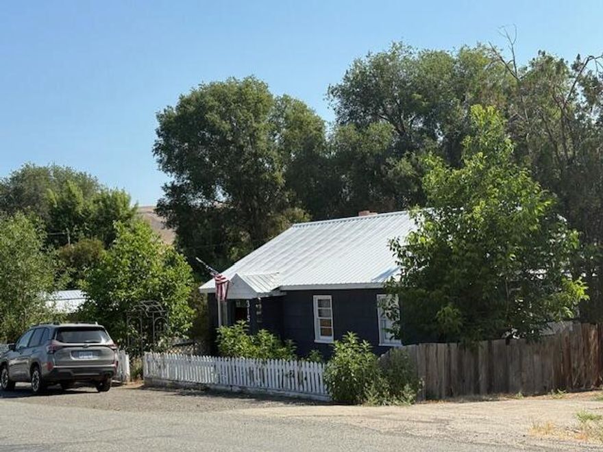 Cozy Dayville Home w/Country Charm!  Located off of the south fork road and is within walking distance to the city park, great opportunity to live in a small rural community, living room features wood accents, kitchen features wood cabinets, vintage sink & dining area, 1550 sq ft, primary bedroom, guest bedroom, guest bath w/full tub/shower,  large sunroom/office area, upper bonus room, large walk in pantry, laundry area, wood & oil heating, carpet & laminate flooring, covered front porch, metal roof, back patio, fenced yard, garden area, fruit trees, berry bushes, detached garage/workshop, on and off street parking.  $226,500  #1162