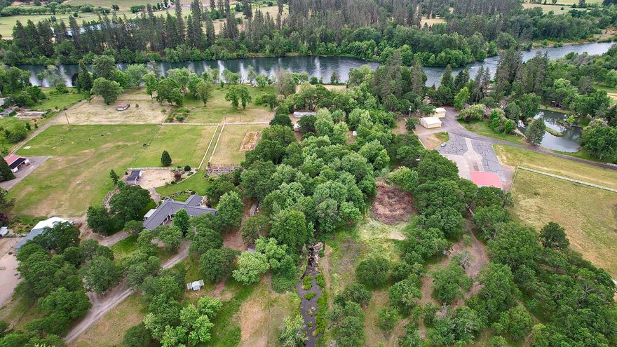 Total 20.91 acres and 2 Tax lots including one 10.02-acre Rogue River Front property and one connecting 10.89-acre land on Modoc Road, well known for Horse Ranches, Farms, Vineyards and gorgeous properties that follow the Rogue River. Zoned EFU with irrigation rights from the Rogue River. Local to the Medford Airport. Gated and fenced for livestock and security. The River Front property has a 1200 sq ft shop and a Mobile home, with year-round creek, well, power and septic. The connecting land is a flat, usable and lightly rolling property for hay or other crops that you may be interested in cultivating. Enjoy your acreage of privacy, fishing and rafting on the Rogue River, hiking Table Rock, boating at Lake of the Woods and Lost Creek Lake or just enjoy the river from your front yard. Two Tax lots are possible for two homes and can also be purchased separately (see listings for 12240 Modoc Road #A and #B). Realtor must accompany all potential buyers for access.