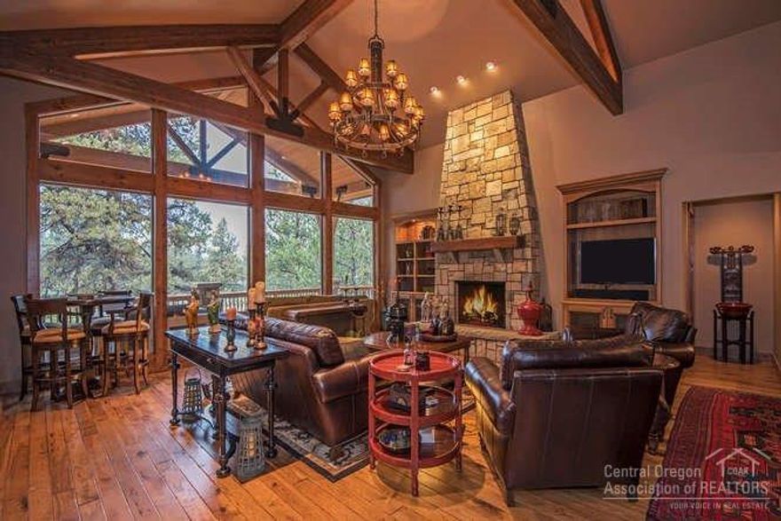 Location, stunning style, and masterful elements of detailed construction find harmony in the heart of Sunriver. Nestled on just over .29 of an acre with golf course frontage of the 13th Fairway on the Woodlands golf course surrounded by Ponderosa pines, Aspens, and common area is this stunning 4 bedroom, 4.5 bath custom home re-designed by Pac West Construction in 2007. With floor to ceiling windows this home is adorned with high quality finishes including a great room with floor to ceiling rock wood burning fireplace, expansive wood vaulted ceilings with exposed trusses and hardware, and dining area. Highlights also feature large gourmet chefs kitchen with professional gas cooktop, oven and built in cabinet front appliances, furniture inspired center kitchen island/breakfast bar with solid granite surface, impressive backsplash and hardwood flooring. Wine bar. Office. Dual master suites each offer decadent tile and slate baths with private access to both of the spacious decks.