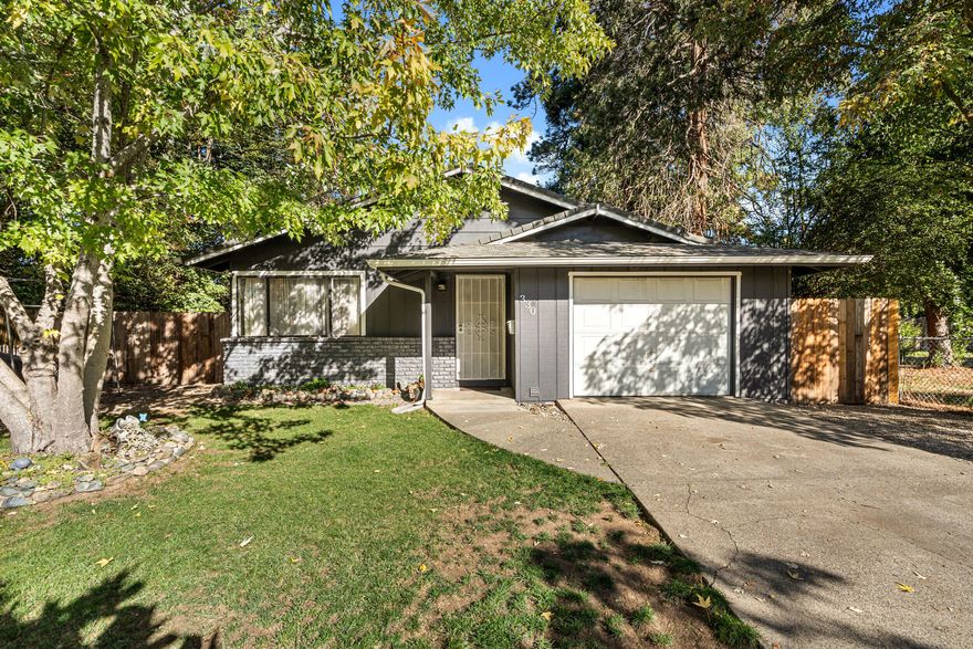 Welcome to 330 SW K St, a charming 2 bedroom, 1 bathroom home perfectly located near downtown Grants Pass. Step inside and you'll find a spacious open living area that flows naturally into the dining space, creating a warm and inviting atmosphere. The home features new LVP flooring, newer carpet, fresh interior and exterior paint, and a newer hot water heater, making it move-in ready.

Where this property truly stands out is the backyard. Gilbert Creek runs right through it, offering a peaceful and private setting that feels like your own personal retreat. Whether you're sipping your morning coffee, reading a book, or simply enjoying nature, this backyard oasis provides the perfect escape.

There is one designated parking space with an additional area to the left for extra vehicles or RV parking. This home combines convenience, comfort, and a touch of natural beauty just minutes from all that downtown Grants Pass has to offer.