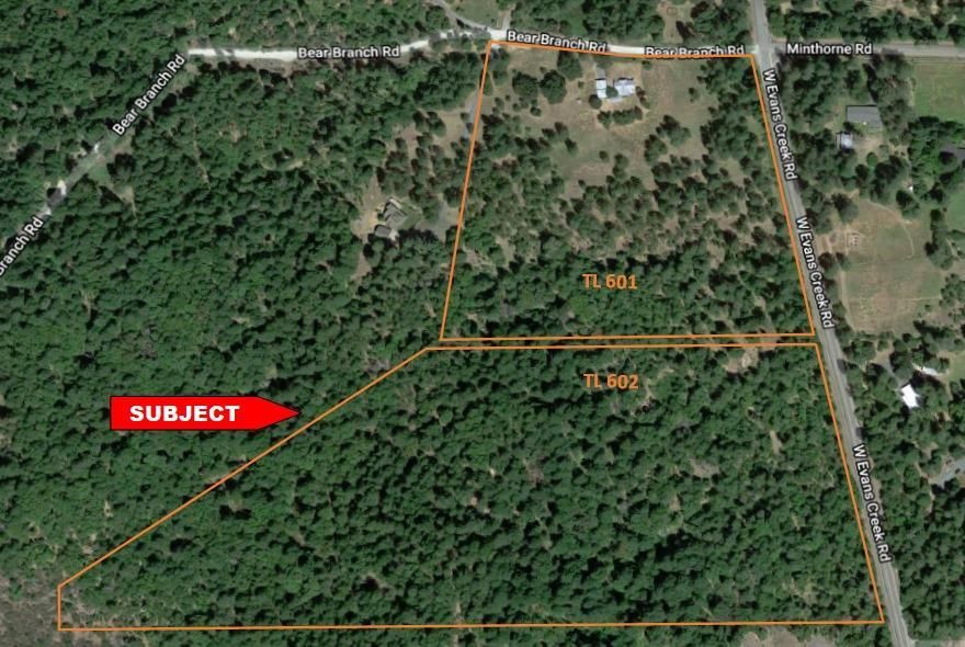 Great New Price! Multiple Rural Home sites with Trees and Privacy! Just 6 miles from the City of Rogue River, this 21.56 acre lot has an approved home site, older structure to remodel or preserve home site, installed septic, soaring pines and oaks, rolling and sloping forested ground, plus two additional legal home sites per Measure 49 claim. Buyer to do due diligence, but should be manageable to split this home site parcel to create two more buildable lots for an development project or three-family setup. Great potential and priced to sell!!