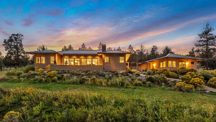 Unique living experience in Bend, Oregon. 
UNBEATABLE LOCATION: Privacy on nearly 10 acres in coveted West Tumalo with direct access to hiking, biking and horse trails. Just 10 minutes to Costco and Traders Joes, and only 15 minutes to Bend's desirable westside.
This contemporary, single-level home by award-winning Tozer Design offers a unique living experience, sustainably designed and built to Earth Advantage Gold standards. The open layout features a sun-drenched great room with a wall of glass showcasing a lush meadow and native trees. The stunning kitchen complete with island seating & breathtaking views is perfect for entertaining. A thoughtfully designed primary suite includes a spacious wardrobe hall leading to a luxurious bath featuring a soaking tub & walk-in shower. A zen garden-inspired breezeway connects the main house to a 376 SF studio with a full bath - ideal for an office, studio or overnight guests. Plus, enjoy the convenience of 7.5 acres of underground irrigation
