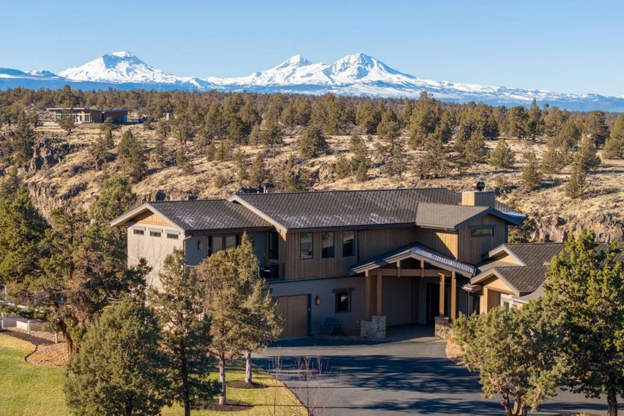 In today's fast-paced world, we all yearn for a true connection to nature, & this extraordinary property provides the perfect escape. Set against the serene backdrop of the Deschutes River & framed by breathtaking mountain views, this home has been meticulously designed to harmonize with its stunning surroundings. Spanning 4,078 square feet & a thoughtfully crafted floor plan that maximizes natural light & seamless flow between indoor & outdoor spaces. The chef's kitchen is a true highlight, outfitted with sleek granite countertops, stainless appliances, & ample storage. With 4 beds & 4.5 baths, every inch of this home exudes luxury & comfort. The upstairs primary suite offers sweeping, unobstructed views of the river and mountains, creating an ideal retreat. Two spacious ensuite bedrooms on the main level. Detached garage is perfect for a workshop, while the adjoining flex room can easily transform into an office/gym or studio. A harmonious blend of modern living & nature's beauty.