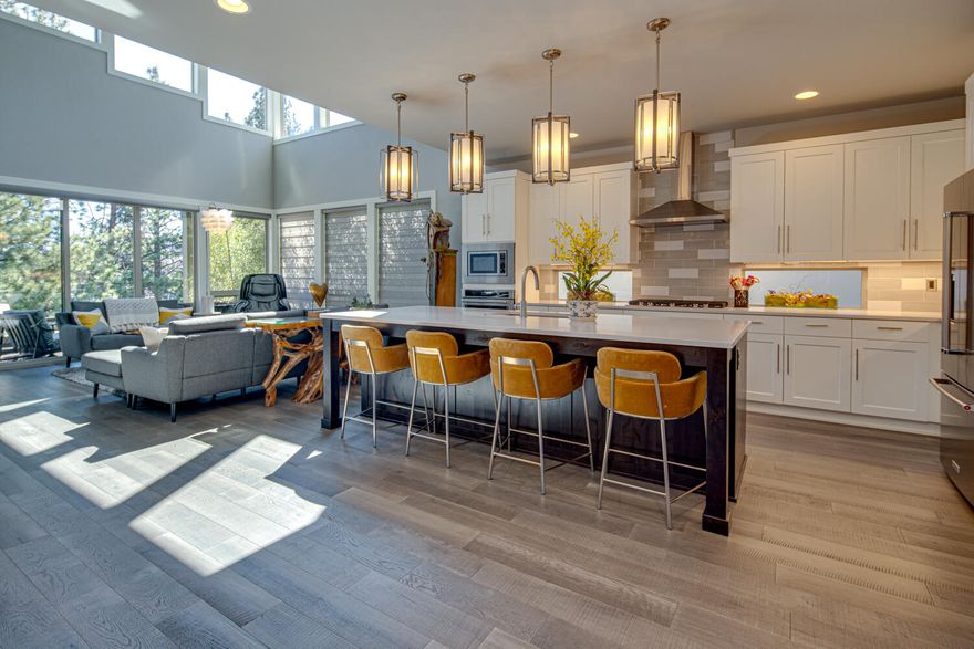 Charmingly placed on the Deschutes River, this beautiful home is luxury at it's finest. Walk into this home, listen to the river on the back covered patio and you won't want to leave. In this versatile 3003 sq ft. Redford town home you'll experience a 2-story great room w/gas fireplace, main level master suite with soaking tub & w/in closet, upstairs guest suite, additional large bedroom & loft area with wet bar, large mud room/laundry with Washer/Dryer, and an abundance of built-ins. Gourmet kitchen with KitchenAid Stainless appliances including refrigerator and modern range hood and cooktop.  You'll love the private access to the river that this community affords. Included are numerous Smart home features, climate control, custom blinds, California Closets through out and so much more that complete this beautiful home.