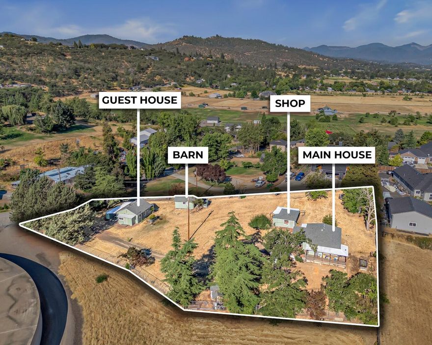 Searching for the perfect 2 family set up in the heart of rural SW Medford at an affordable price? If so, this is the one for you! This charmer features 2 detached homes, 1.16 irrigated (TID) acres (underground irrigation piping runs through the property), amazing views of the valley, multiple shops, & much more! Main house has been completely updated inside & out since the owner purchased the property in 2017 & features 2 bedrooms, 1 bathroom, 930 sq ft, galley kitchen (Fir countertops, quality appliances), tub/shower combo, mini split system, deck, vinyl flooring, central vacuum system, & amazing views of the valley from the living room. Guest house features 2 bedrooms, 1 bathroom, 648 sq ft, attached carport, mini split system, galley kitchen, & spacious living room. Since 2017, owner has installed new 200 panels, new roofs, new interior/exterior paint, new sewer lines, & various other updates. Both homes are connected to city services-no need to worry about well & septic issues!