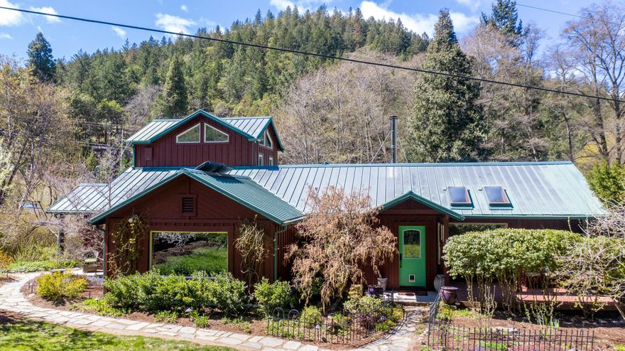 One-of-a-kind 20-acre retreat on Wagner creek. In-ground pool, sauna, hot tub & 5 permitted buildings in superb condition: 2 dwellings, utility building/studio, straw bale art studio & luxury camping cabin, all with solar! The entire property is manicured to perfection w/ botanical gardens, pathways, orchard, private gated entrances, root cellar, deer-fencing, year-long creek, water rights and superior irrigation system. Main house: all main-level living; grand owner's suite w/ walk-in closet & loft/sunroom; guest bedroom; office; 2 full bathrooms; kitchen & dining w/ access to deck; living room w/ Tulikivi radiant heat/pizza oven; & covered porches. Retreat hall/ADU: spacious w/ cathedral ceilings, wood floors, full kitchen, full bathroom & deck w/ retractable awning. Utility building: studio w/ bamboo floors & balcony up, food-prep kitchen, full bathroom + garage/workshop down. Tranquil, creekside straw bale art studio. Camping cabin: in meadow w/ woodstove & battery-powered lights.