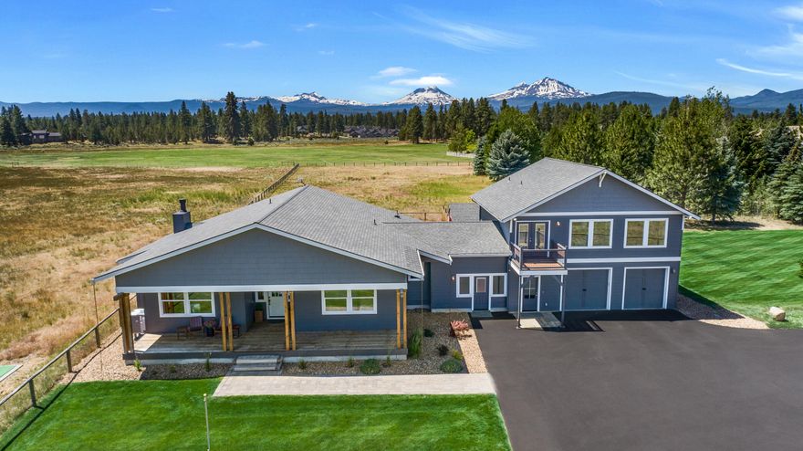 Experience breathtaking Cascade Mountain views from this serene 15+ acre retreat bordered by Indian Ford Creek and its wildlife filled meadows. Designed for peace and privacy, as if you are endlessly on vacation, this single-level home blends modern comfort with nature's beauty. Expansive windows fill the open-concept living space with natural light and framed views of the Three Sisters and Broken Top. A separate entrance leads to a private 2-bedroom ADU with full kitchen, bath, laundry, and incredible Mtn and meadow views of its own—ideal for guests or multigenerational living. Modern finishes throughout and a wood burning fireplace all enhance the seamless indoor-outdoor experience. Additional features include a high efficiency zoned heating system, steam shower, 3-car garage, and a 16'x22' red metal barn with concrete floors - perfect for storage, hobbies, or small livestock. All this yet only a mile from downtown Sisters, a rare blend of natural beauty, comfort, and convenience.