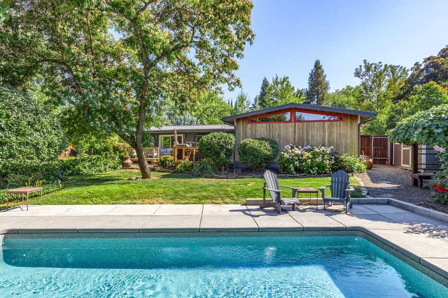 You will feel immediately at home in this beautifully designed & completely remodeled one level mid-century modern home right in the heart of Jacksonville. Private location on 1/3 acre yet only one block from Rays! Incorporating vaulted ceilings, built-ins, & clerestory windows, this home captures you w/ the details that turn a house into a home. The home features an open concept floorplan, bedrooms in separate wings, & views to the stunning backyard. The kitchen has a stainless Subzero fridge & Wolf stove, abundant storage, & a bar for entertaining. A mud room w/ a wall of built-ins leads to a covered carport, storage area & room for an RV w/ hookups. The backyard is designed for entertaining w/ a back deck accessed from both the dining room & primary, to the heated pool & patio area w/ remote retractable awnings, separate seating areas, & a finished shop/garage w/ heat & a/c, all set in a lush, private landscape. Amenities include solar, tankless water heater, & ductless HVAC.