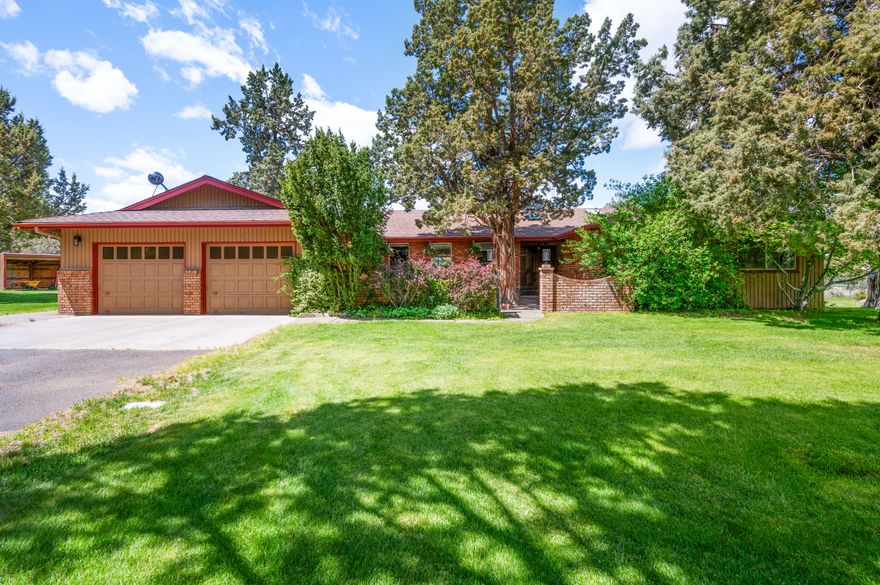 Embrace iconic Central Oregon living in Tumalo's premier neighborhood. Tucked on a quiet private road with sweeping Cascade views and a west-facing backyard, this 3-bed, 2-bath ranch-style home sits on 4.79 acres with rare irrigation rights. A refreshed kitchen, rich hardwood floors, spacious bedrooms, and a flexible office or bonus space blend comfort and style. Enjoy peace of mind with a new roof and HVAC, and unwind in the welcoming front courtyard. Outdoor living shines with a tennis/pickleball court, 624 sq ft attached garage, plus a 1,174 sq ft detached 3-bay garage with RV parking and extra covered space. Just steps to the Deschutes River and endless trail access, this ADU-eligible property offers unmatched beauty, privacy, and room for all your hobbies—making it a true lifestyle destination. Whether you're entertaining on the patio at sunset, launching into outdoor adventures, or simply soaking in the mountain views, this property captures the essence of Central Oregon.