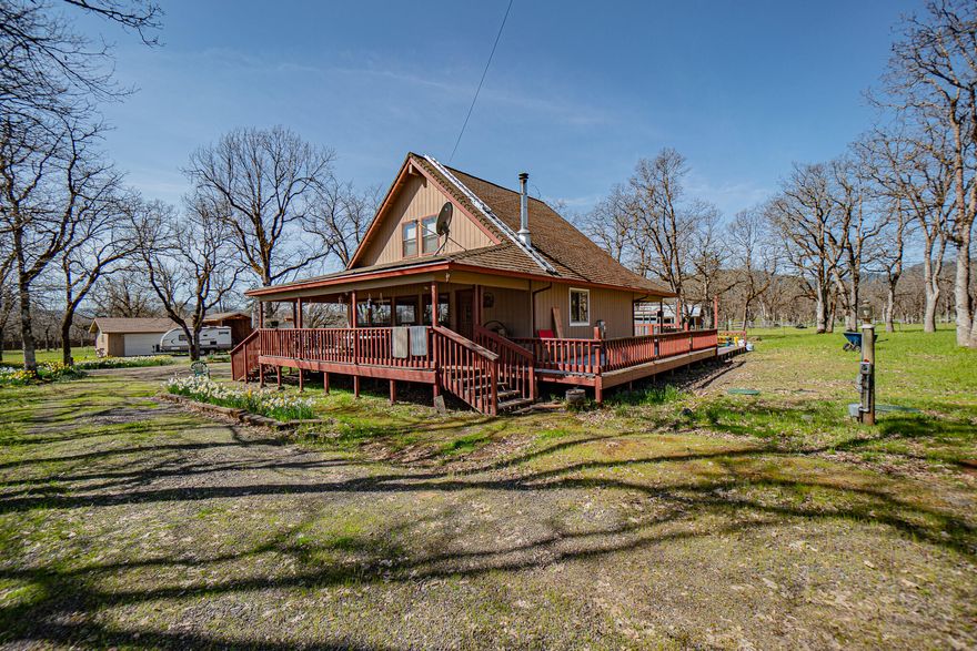 This beautiful hobby farm is a perfect set up. The home sits on 5 acres and has several oak trees in a country setting. The home, built in 1989, has a wrap around deck which is perfect for entertaining. Downstairs you will find a living room, dining area, primary bedroom, kitchen, laundry room and 1.5 bathrooms. Upstairs you will find a landing area for a family area as well as two additional rooms being used as bedroom and another full bathroom separating the two. The home has vaulted ceilings and plenty of natural light flows within. Outside you will find a garage/shop and a carport as well as several sheds. There is a beautiful barn with four stables and a tack room. The property is very useable! Abundant flowers grow throughout the season. Don't miss the rare opportunity.