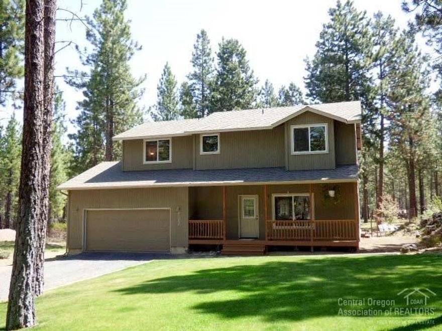 Fantastic setting on .93 acre lot, large ponderosa pine trees in a cul-de-sac which backs the lava flow. Open floor plan, wonderful bamboo hardwood floors, huge family room w/stone accent fireplace & knotty pine mantle. Attractive center island kitchen, hickory cabinets, new smooth top range, breakfast bar & lots of counter space. Spacious main level master suite, sliding glass doors, walk-in closet, sitting area. Inviting back deck, heat pump/central AC ready, covered front porch & great rock outcroppings.