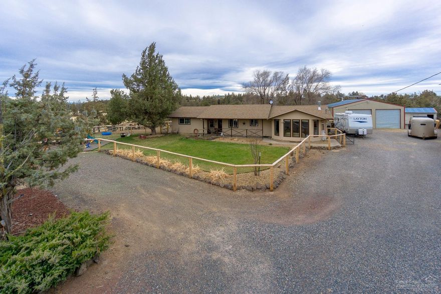 A rare opportunity to call the Smith Rock Valley home. Situated on the East side of Smith Rock State Park, across the street from Ranch of the Canyons, this 5+ acre property is set up & ready to go for your family, horses & pets. Over 1800sf of single level living, 3 beds, 2 remodeled baths, bonus room & huge mud room. Granite counters in the open kitchen & dining. 24x36 shop with 220, RV parking, fenced & cross fenced. Well, wood burning fireplace, covered back patio & an amazing view!