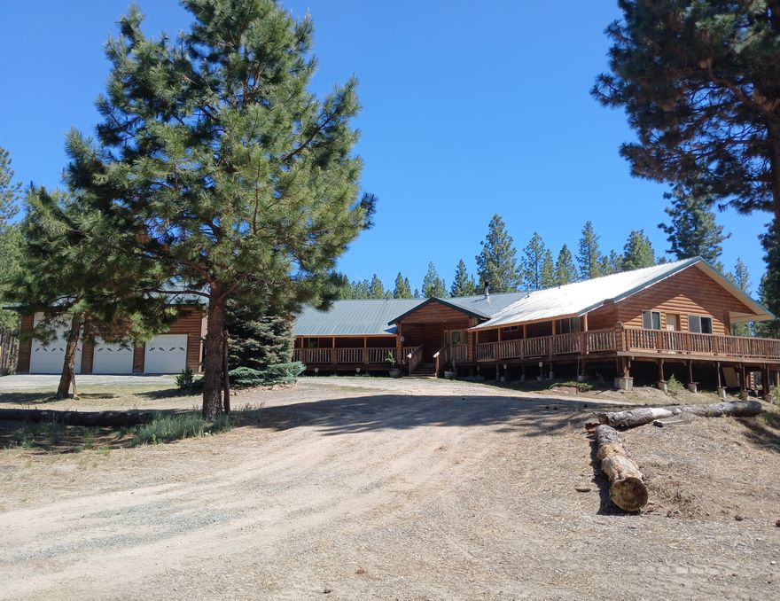 Owner is currently in the process of improving the property by connecting to public power w/completion expected to be in early December. Nestled in the woods, it has  privacy & beauty in a natural setting located at the end of the road & near the Fremont- Winema National Forest. Spacious open floor plan w/open beam ceiling, woodstove, walk-in pantry, & mud room. Kitchen has large island, stainless appliances, & custom cabinets. Master bedroom has exterior door to deck for those amazing high desert sunsets, walk-in closet, & bathroom w/granite shower & double vanity.  In-law quarters has open living room, kitchen wet bar, 2 bedrooms, & full bath. Wood laminate floors & granite countertops throughout. Full concrete floor basement w/wall safe. 40'x50' concrete floor shop w/40' RV bay & sewer dump, 2nd story for additional storage. 26'x31' carport for additional parking & storage. Fenced, gated, w/2 wells, mature fruit trees & garden. Lots to offer at this price w/endless possibilities.