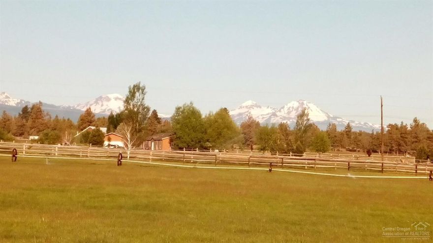 Magnificent views! Fantastic location! 9.85 acres in very desirable Tumalo, close to shopping, restaurants & recreation. Land is fenced and cross-fenced with 5 acres irrig. rights, well, horse barn and picturesque pond. Manu. home is very livable, plus double garage. This is the perfect spot to build your new custom home overlooking pastoral and Cascade mountain views!