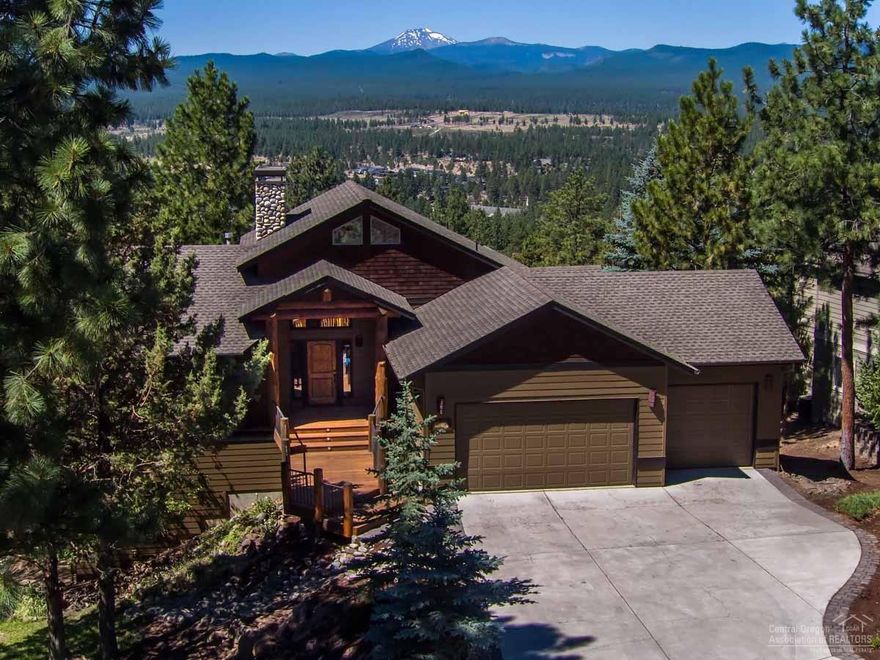 Breathtaking unobstructed Cascade Mountain views from nearly every room! Great room with a 20' rock fireplace and large windows. Main level master, with custom built-in cabinetry and walk-in closet, opens onto the upper deck. Downstairs has two suites with full bath and a family room with custom copper bar. Lodge-style accents, custom finish work, Australian cypress floors. Extensive outdoor decking - perfect for entertaining or watching sunsets. Two water features and a three-car garage on a .28-acre lot.