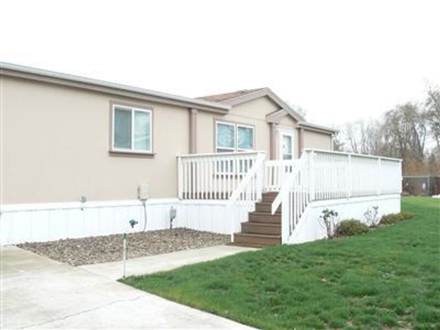 Beautiful home in San George Estates. Absolutely move in ready! 3 bedroom 2 bath with split floor plan. Newly painted inside and clean as a whistle. Home is situated on a large lot in cul-de-sac in all age manufactured home park. Vaulted ceilings throughout, built in entertainment center in Living Room. Double walk-in closets in master bath. A must see! Large gated deck in front. Patio area and shed in back on very large lot. Park features pool, clubhouse, and playground facilities.