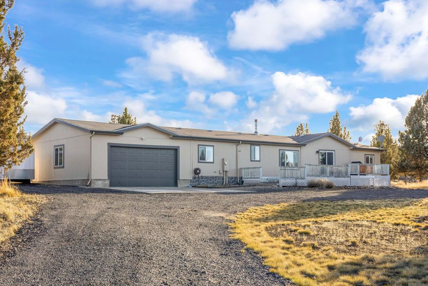 Discover the perfect blend of space, privacy, and convenience in this large, open floor plan home set on 2 peaceful acres just minutes from town in Prineville. Designed for comfortable living, the home features three very large bedrooms, offering plenty of room to relax and unwind. The open layout creates a bright, welcoming atmosphere, centered around an amazing wood stove that adds both charm and cozy warmth. Step outside to the newly covered back porch and enjoy quiet mornings, evening sunsets, and abundant wildlife in a truly serene setting. With a true two-car garage, a large storage shed, and plenty of elbow room, this property offers both functionality and freedom. Quiet, private, and close to town, this is Central Oregon living at its best