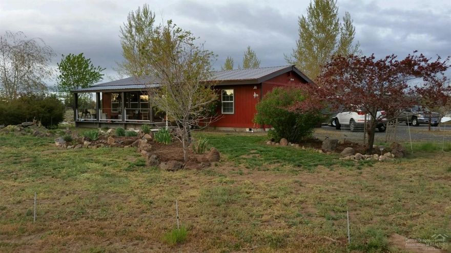 Cute 2 bedroom, 2 bath, single level home on 1.82 fully fenced and gated acres. Vaulted ceilings. Great room has wood floors, wood burning stove and French doors. Granite counters and eating bar in kitchen. Reverse Osmosis system in the kitchen. Covered front and back porch. Oversized and foam insulated 2 car garage with additional side room for hobbies or shop. Greenhouse, chicken coop and raised gardening beds.