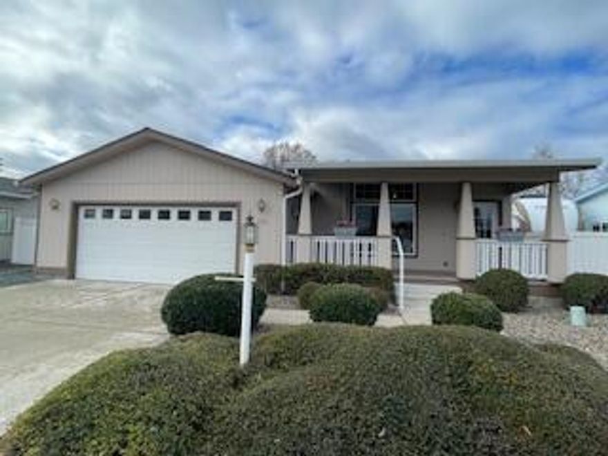 This well cared 2-bedroom, 2-bathroom, 1394 sq. ft. manufactured home blt. in 2005 is located in the desirable 55+ community of Miller Estates in Central Point.  With its low maintenance landscaping of plants & river rocks, you can sit on the covered front porch & enjoy this quiet community.  The attached 2 car garage is complete with a new garage door opener.  When you walk in, you'll feel welcomed by the open-floor plan, large windows, vaulted ceilings & ceiling fans. The kitchen has a double sink, solid oak cabinets, a built-in pantry, NEW stainless-steel appliances, & an island w/lots of storage. Dining area has a slider to patio w/a view of the West Hills.  The office/craft room could become a 3rd bedrm. if needed.  The home has been newly painted inside, new trim throughout.  Both baths have NEW counters/sinks & toilets.  Indoor laundry, Primary has 2 closets & bath w/ step-in shower. Newer HVAC approx. 2023, New blinds & new roof!