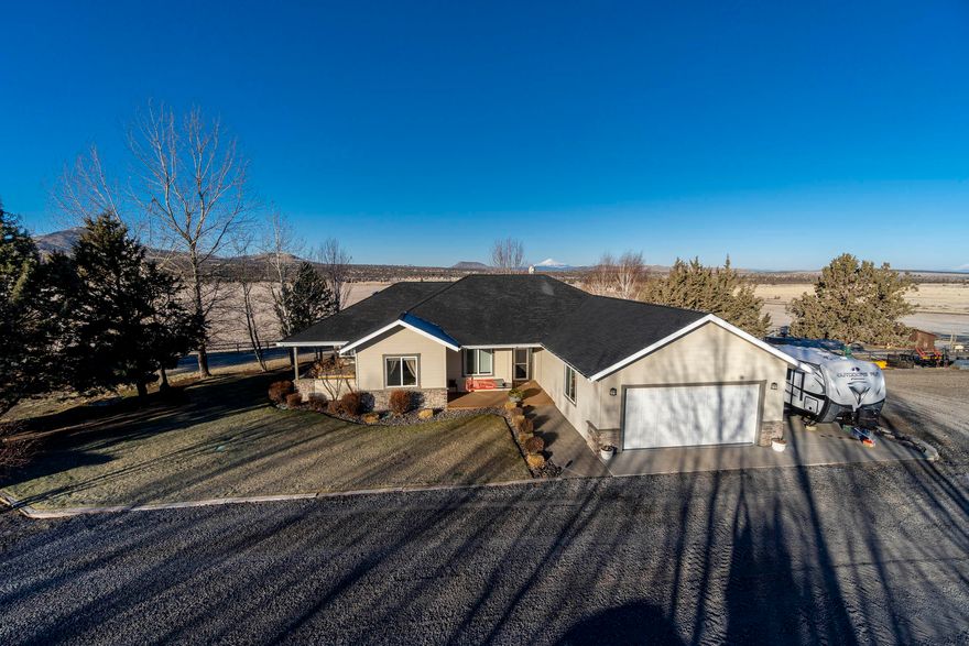 Facing the beautiful Cascade Mtns is an exceptional 2400 sq ft custom home overlooking a High Value ODA Certified Weed Free 160.04 acre horse hay farm/ranch with 125 irrigated acres by its own private well.  Property irrigated with a full circle pivot with VFD pump, flow meter, and LESA-LEPA sprinkler system for higher efficiency.  Equipped with two large hay sheds, barn with corral and perimeter fenced pasture, machine shed/shop, and chicken coop makes this a perfect farm/ranch property.  Bring your horse or 4-H projects.  Property borders public lands on 3 sides for endless horseback riding or hiking.  ATVs allowed on existing roads only.  This beautiful home's kitchen is nicely appointed with maple cabinets, expansive granite tile counter tops, a Jenn-Air induction cook top, French door ss refrigerator, and pantry with slide out drawers.  A large pantry room has shelves 10 ft high.  Outstanding Cascade Mt. views from every window on west side of home.  Must see!