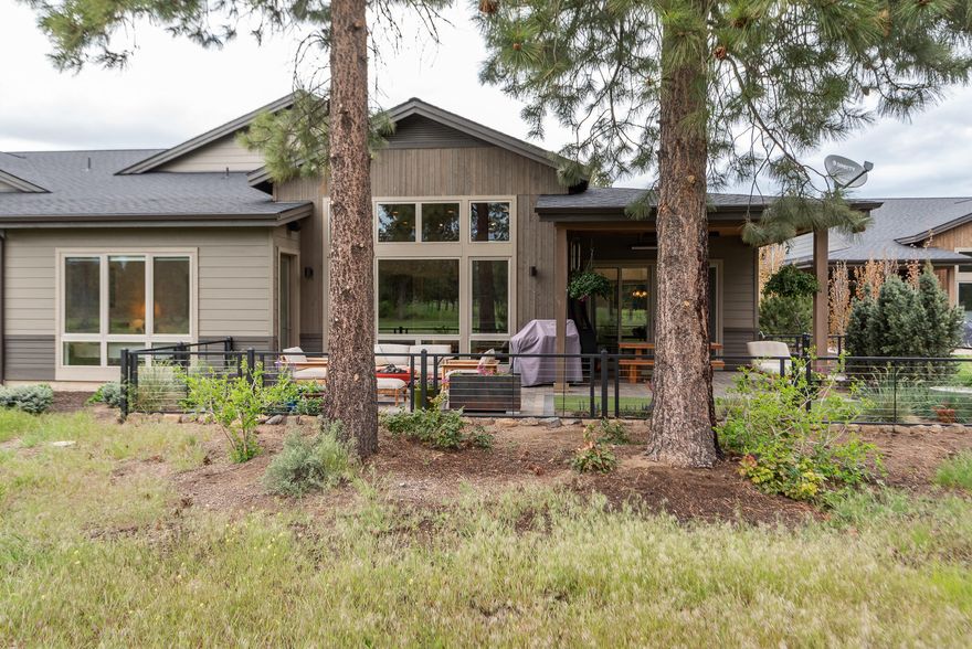 Welcome home to carefree living at 1925! Perfectly situated on the10th fairway of the Bend Golf & Country Club is a a gorgeous mid century modern, single level townhome. Incredible natural light with floor to ceiling windows that invite the outdoors in and overlook the expanded patio with a fire-pit and a water feature. Stunning tongue and groove wood ceiling featured in the entry and great room. Spacious gourmet kitchen featuring JennAir appliances, a wine fridge, quartz counters, desk area, a pantry and the perfect island for entertaining.The primary suite boasts dual vanities, soaking tub, steam shower and a customized walk-in closet. The junior suite and office are nicely separated from the primary suite. Hardwood and tiled floors throughout the home. Peaceful outdoor living with a fully fenced backyard, heaters and speakers to enhance your experience. The oversized 2 car garage has hanging racks and cabinetry as well as additional golf cart storage. Don't miss this home!
