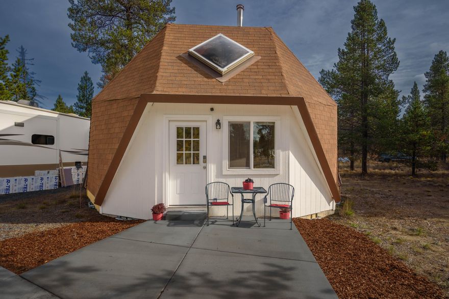 Unique geodesic dome retreat with a ton of character and modern upgrades. Private loft offers flexible living space perfect for a bedroom, office, or guest room. Features include granite tiled countertops, newer flooring and windows, cozy certified wood stove, concrete patio, paved driveway, and a corner lot with easy access to town. Ideal as a short-term rental or personal getaway.