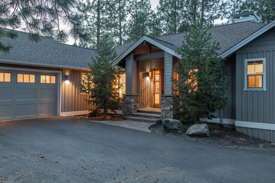 Custom-built by Pacwest Homes and located in the prestigious community of The Reserve at Broken Top, this stunning property overlooks community open space with public trail featuring direct access to Phil's Trail system. The open floorplan is anchored by the vaulted great room with wood beam accents, a stacked-stone floor-to-ceiling wood-burning fireplace with custom wood mantle, built-in speakers and access to the enlarged deck with stairs to the backyard. The upgraded kitchen features built-in fridge/freezer, newer white cabinetry, full-tile backsplash & white quartz countertops. The primary suite sits on the east wing of the main level, with the finished basement featuring two guest bedrooms, a full bath & a large bonus room with access to the private, screened hot tub. Topped off with a 3-car garage with a storage nook for your toys.