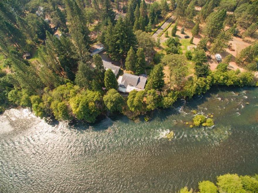 Rogue River Legacy Property! 4-Bedroom, 2-bathroom, 2,344 sq. ft. cottage style home in a park-like setting on the Rogue River. 3.67-Acres with approx. 400-feet of Rogue River frontage. Recent remodeling - hardwood floors, bathrooms and all new windows. There is a large covered deck along the river and easy river access for fishing. Hot tub on deck overlooking the Rogue. There is a clubhouse that has a large game room or party room, guest quarters and a covered patio with an outdoor fireplace, sink and prep counters. 6-Car garage, RV garage, tool shed and large carport. There are large Evergreen trees, apple trees and a garden area. Great fishing hole for salmon and steelhead.
