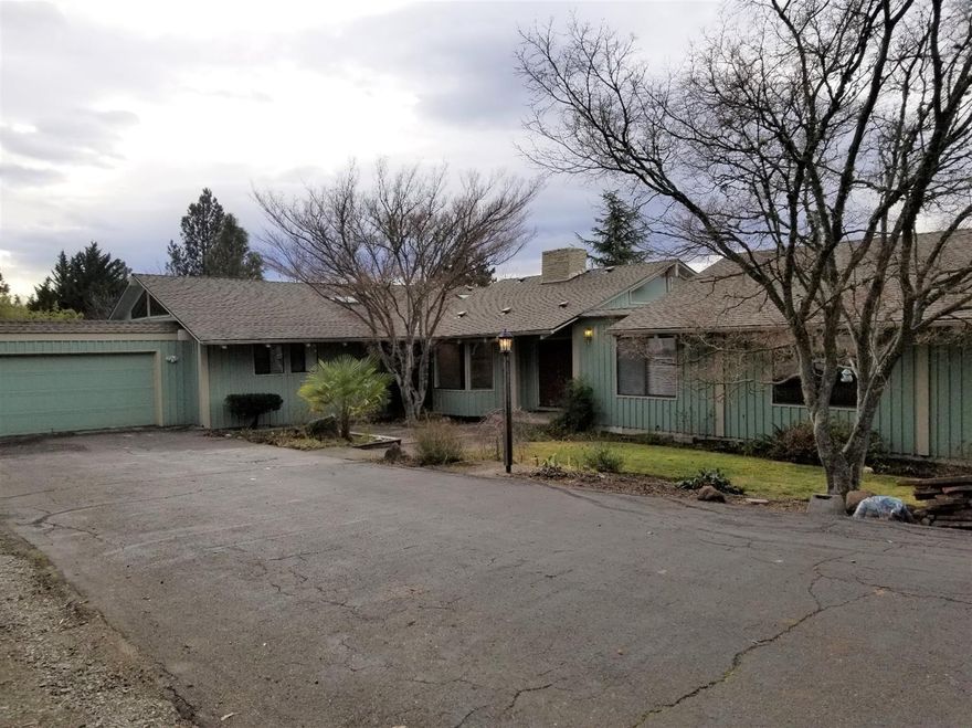 Large, single level home on nice sized lot in East Medford hills. Large Bedrooms, sunken living room with slider to the deck with west facing views. Kitchen opens to dining area with second slider to deck and separate family room. Hardwood floors in common areas and new carpeting in bedrooms. Some windows have been updated. High end HVAC new in 2016 with metal ducting. Roof new in 2015. Exterior has flagstone sitting area with 2 waterfalls leading to beautiful large Koi pond with amazing filtration system, fruit trees galore, room for chickens and nice sized garden area with drip irrigation.