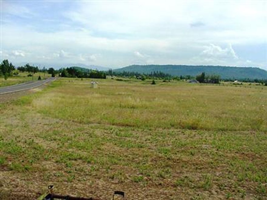 Here's your opportunity to own 4.26 usable acres in Sam's Valley. 30 GPM Well is already in. Septic & Homesite is approved. Ready to build your dream home or move on your new manufactured home. Great corner location, Seasonal Creek and Nice quiet established neighborhood. Country living but only 20 minutes to town and 1.2 miles from Rogue River. Unobstructed views of both Table Rocks & Mt. McLoughlin. Located at the corner of Beagle & Dodge Roads. Drive by and check it out!