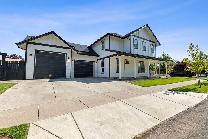 Welcome to this stunning custom farmhouse on a desirable corner lot! This 3-bedroom + den on main floor, 2.5-bath home blends charm and efficiency with a bright, open layout and high-end finishes throughout. The spacious kitchen features quartz countertops, stainless appliances, full tile backsplash, and a large pantry—perfect for entertaining. The primary suite offers dual vanities, dual walk-in closets with built-in organizers, and a luxurious tiled shower with bench. Enjoy the inviting wrap-around porch, upgraded flooring, and recessed lighting. Energy-efficient solar panels keep the average electric bill around $12! Fully landscaped with sidewalks for easy strolls to nearby parks and schools. Additional highlights include a gas fireplace, tankless water heater, two 220V garage outlets, and wiring for a hot tub. Solar to be paid off at closing—move-in ready and beautifully maintained