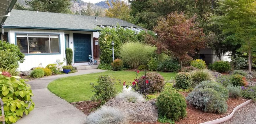 Your Dream home is move in ready river front, minutes from boat ramp,your own river access for rafts,fishing etc!Property has circular drive,set back making boat and RV parking possible. Home sits on paved country road with limited traffic,minutes to downtown Grants Pass or Rogue River for recreation, medical, shopping. Home offers beautiful views of mountains, and the Rogue River; is light,bright and cheery, lovely large deck overlooking the river from front room & master bdrm where you can relax and enjoy. Kitchen offers wet bar, granite counter tops, island with cook top, cozy breakfast nook area,lots of counter space and cabinets, Central Vac system. Master suite has outdoor access, river view. Full bath dual sinks, private garden. 2 bedrooms away from master; a partial basement w/storage, a workshop area inside over sized 2 car garage w/utility sink w/hot and cold water. Front offers low mnt.landscape. Kohler whole home generator with a switching system as back up for the home.