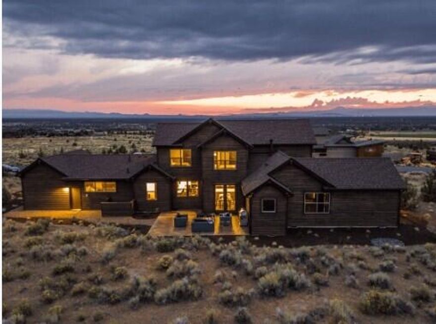 Perched on coveted Rangeland Drive in Brasada Ranch, this contemporary ranch-style luxury retreat pairs clean design with postcard Cascade views. Behind the wrap-around porch, 3,425 sq ft of light-filled living unfolds: a great room framed in stained knotty alder, gourmet kitchen with walk-in pantry, quartz surfaces, a 10-ft island and bar seating, plus an adjacent pocket office. The main-level primary suite captures mountain vistas, pampers with spa-tile shower, soaking tub, and walk-in closet. Three additional guest rooms, a flexible fifth bedroom/bonus room upstairs, plus three luxe baths. Earth Advantage certification ensures year-round comfort; also features a stamped-concrete patio, paver drive and oversized insulated 3-car garage. Ownership unlocks Brasada Ranch amenities including athletic center with three pools, 18-hole championship golf course, spa, restaurants, trails, equestrian center, fishing, and more. Experience Central Oregon luxury as it should be.