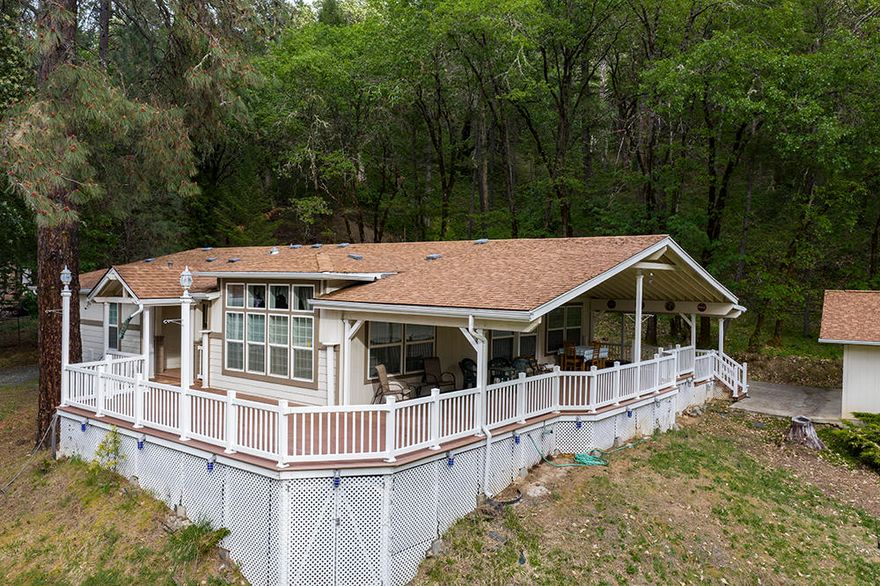 Contemporary 2001 Built 3 Bedroom, 2 Bath 1,916 Sq Foot Triple-Wide Manufactured Home on the Rogue River! Enjoy an Open Concept Floor Plan with Vaulted Ceilings that features Living & Family Rooms, a Nice Dining Area, & Lovely Kitchen with Tons of Cabinetry. Spacious Master Suite offers Dual Vanities, Garden Tub, & Walk-In Closet. The Huge 1,400 Sq Foot Mostly-Covered Composite Deck provides Fantastic Outdoor Living Space & tons of room for Entertaining, or Relaxing & Enjoying the Pretty Views. You will enjoy some of the most stunning River & MountainViews in the area. Additional Amenities include a Paved Driveway, & a Finished & Insulated 960 Sq Ft 4+ Car Garage Shop. This Property is in Two Separate Legal Parcels, Directly Backs BLM, & has Rogue River Frontage across the Highway! As an Added Bonus, with an Acceptable Offer to Seller, this Home is being sold with ALL Remaining Personal Property in the Home, inclusive of Quality Furnishings & a Massive Coca Cola Memorabilia Collection.