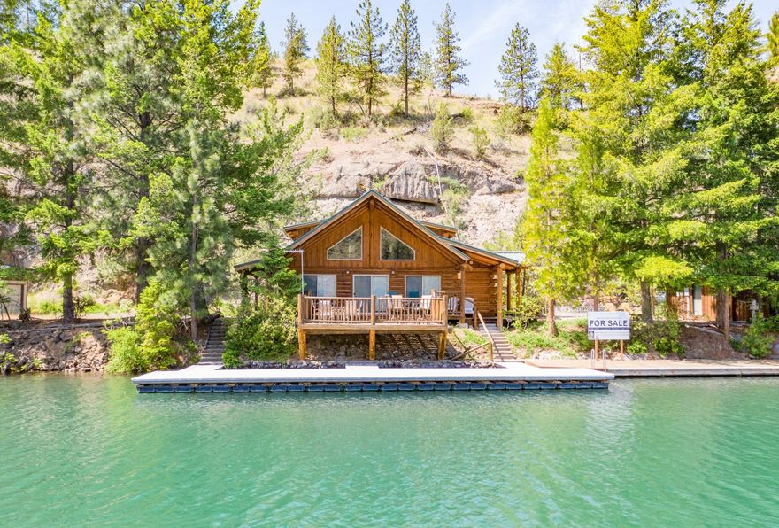 Rare property located on the Metolious River Arm of Lake Billy Chinook in Street Creek, w/aprox. 120 ft of water frontage. Off-the-grid w/full solar system, shared well & septic. Totally remodeled custom log home, 3BR, 2 Bath, open concept, + loft, custom kitchen, over 1260+ sf wrap-around decks (800+ covered) and 1550 docking/swim platform w/dry dock/boat lift. Absolutely move-in ready. Gated so must call LA for access. LA must accompany.