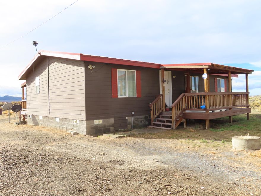 This 2006 Marlette Manufactured home features an open floor plan and is a 3-bedroom, 2-bathroom residence with about 1113 Sq Ft of living space. Nice covered front  & back porch/deck too. Situated on a approximately one-acre with a tree lined driveway(park like setting), this property offers a unique living experience in the high desert region, specifically near the unincorporated town of Christmas Valley. One of the distinctive features of this location is its proximity to an airstrip. This allows residents to watch planes take off and land, which can be an exciting and unique pastime for aviation enthusiasts. Plenty of space to add a shop or garage or both, as well.