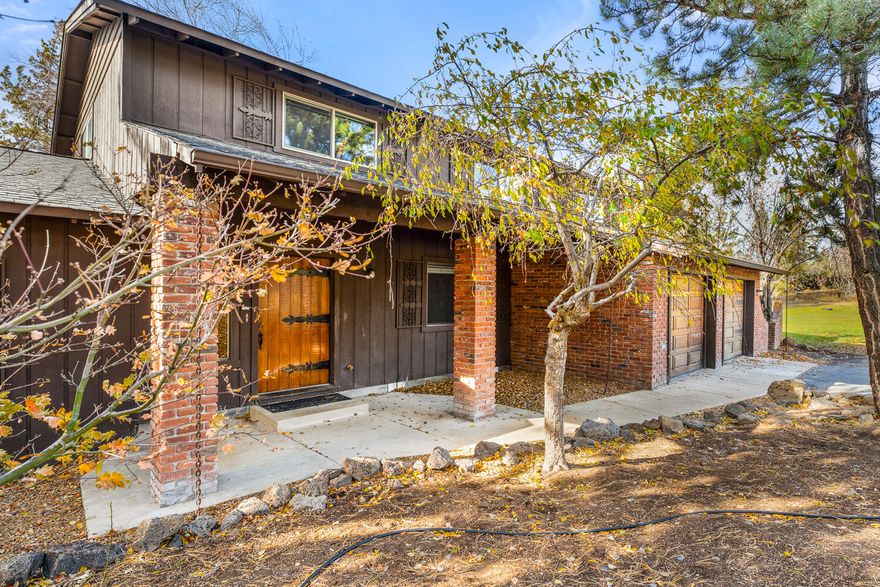 Gorgeous small acreage in NE Bend's Wallace Acres rural subdivision! Nestled on a peaceful cul-de-sac, this 4 bedroom, 4 bath, 2806 sqft two story home sits on 2.17 acres with 2 acres of COI irrigation rights. The home boasts a spacious living room with wood and stone accents, vaulted ceilings, ceiling fan, and a cozy pellet stove, plus a stunning wall of windows that flood the space with natural light. The family room, complete with a woodstove, is ideal for relaxing or enjoying hobbies. A charming kitchen offers a breakfast bar and vintage touches. The upstairs primary suite features wood accents, a walk-in closet, and a private bath with a double vanity. Additional highlights include a built-in sauna, jetted tub, and a 672 sqft barn. The parklike setting, with mature trees, a lush lawn, and a patio, is perfect for entertaining. Enjoy country living while being just minutes from schools, shopping, and the medical center. Don't miss this incredible opportunity. Call your broker today