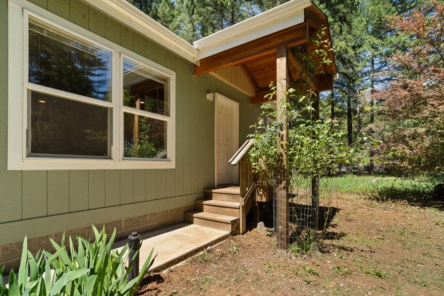 $5,000 Buyer Incentive! Your woodland retreat awaits! This beautifully maintained 2018-built 3 bed, 2 bath manufactured home offers 1,296 sq ft of open-concept living space. A separate 720 sq ft detached unit with a full kitchen and bath is perfect for guests, a studio, or rental potential. Set on 5 serene, usable acres at the end of a quiet cul-de-sac, the fully fenced property features level pasture, mature timber, fruit trees, and plenty of room for gardening or animals. Enjoy good water with a productive 10 GPM well (per log). Peaceful and private, yet minutes from downtown Cave Junction and Hwy 199, this property offers the perfect balance of rural charm and modern convenience. Whether you're seeking a tranquil retreat, multi-generational living, or a small homestead, this versatile property is ready to bring your vision to life. Schedule your tour today and take advantage of the $5,000 Buyer Credit!