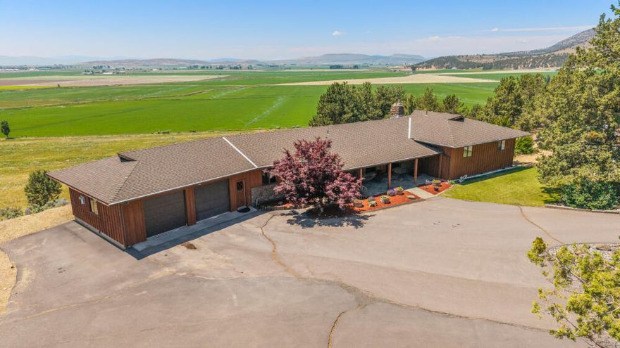 Custom home on 40 acres with a view & room for animals. Great horse property. 5 bed, 4 bath, 2 car garage, 36 x 42 shop. 14.5 Acres of pasture irrigated from new irrigation well. Beautiful wood & rock work with exposed beams. Kitchen features granite counters, a pass-through pantry, breakfast bar, jennn aire range & oven & is open to the dining area & living room with a fireplace just off of it, all share the view of the basin & Mt Shasta & access to large 2nd story deck. Primary suite has a view of Mt Shasta, a brick accent wall sliding door to the deck & a sliding barndoor on the bathroom. In addition, the main floor has 2 more bathrooms, 2 more bedrooms one of which makes an excellent office. On the garage entrance there is a dog/boot wash area, a bathroom & a large laundry room. Downstairs has a family room with fireplace surrounded by rock work & has a propane fire starter, wet bar and access to the deck. There is a full bath, 2 bedrooms & storage room. Heat pump is 1.5 yrs old.