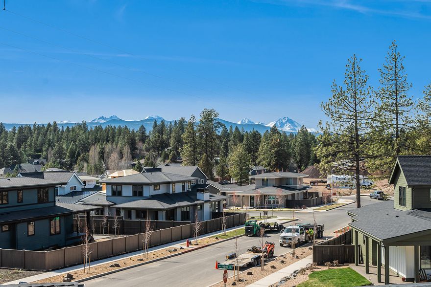 Modern Prairie meets mountain views in West Bend!  Located in Talline, one of West Bend's newest communities, this stunning corner-lot home offers breathtaking mountain views and a prime location near Shevlin Park, schools, and a new commercial district & park. Towering 10' ceilings and expansive windows fill the open-concept main level with natural light. The chef's kitchen boasts floor-to-ceiling cabinets, premium Jenn Air appliances, and custom built-ins. A main-level office provides a quiet workspace with mountain views, while the second level features two bedrooms, full bath, and a versatile bonus room—perfect for a second office with stunning Cascade views. The luxurious primary suite includes heated bathroom floors for ultimate comfort. Enjoy seamless indoor-outdoor living with a generous deck and yard. A two-car tandem garage with an additional parking pad completes this exceptional home!