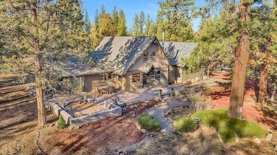 Find yourself amidst the privacy and seclusion of this close-in small acreage property on Bend's westside and feel your cares melt away. Countless pines and junipers shelter a light-filled home with abundant windows, vaulted T&G wood ceilings and generous living spaces. An efficient kitchen gives way to the dining/living area with a window seat, skylights, vaulted ceiling, pine floors and 3/4 bath. The main level primary suite includes a separate sitting/workout area, vaulted ceiling, loft with ladder access & private covered porch. A large soaking tub is the centerpiece of the adjacent primary bath with a glass block & tile shower plus double vanity.  With freshly refinished floors and cleaned carpets, newly painted interior & exterior & new furnace, this home is move-in ready. Studio/shop features 2 distinct spaces, colored concrete floors, a glass garage door & endless possibilities to house your tools or toys. Properties like this don't come up often, don't let it get away!