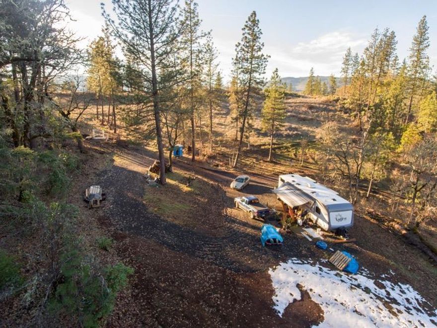 This property located a short walk from the beautiful Rogue River just outside Shady Cove city limits. 4.12ac of land, partially improved with power run to property. Septic installed 1,500 gallon tank, needs leach field installed. Large developed flat for possible home site, graveled driveway, gated entry. Zoned RR-5 this lot has beautiful views of surrounding mountains and view of Indian Creek. Walking distance from city park. Property is partially fenced with a large portion covered in well established hardwood and pine trees. This lot has great potential to build your dream home.
