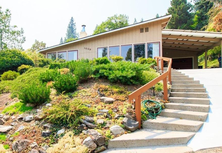 Enjoy views from the living room of this well maintained, single level home located in the hills above Ashland, close to the University. The home features vaulted ceilings, a cozy wood fireplace in the living room, and additional family/dining area also with views. There's a central vac system for convenience, plus decks to the side of the house and a private patio area in the back of the house with Koi pond and water feature. The master bedroom is large with private bath. The kitchen has new flooring and a skylight, and the laundry room is close to the bedrooms for convenience. This home has TID irrigation and is close to schools and shopping, yet also close to hiking trails and Mother Nature.