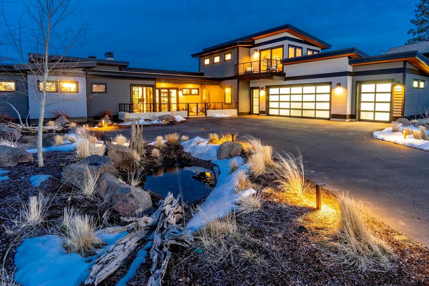 From the moment you enter this showcase home in the heart of Tetherow, you'll feel at ease. Floor-to-ceiling windows bathe the home in light, bringing the outside in. The welcoming great room features soaring ceilings and a modern gas FP w/ custom surround. Entertain guests in the well-appointed kitchen, featuring a huge island with seating for 6, white quartz counters, alder cabinets, & JennAir applcs. Outside, a covered back patio can be enjoyed year-round, thanks to heaters, gas FP, and fire pit. In the north wing, the owner's suite features its own fireplace and tranquil views through slider doors. A spa-like owner's bath offers a sauna & walk-in shower. Another full suite at the other end of the home offers a luxury retreat for guests. Upstairs, find a third bedroom plus office/4th bedroom w/ own deck & mountain views. This home also offers a sunny first-floor bonus room, large laundry room w/ dog bath, 3-car garage, & multiple smart-home features.