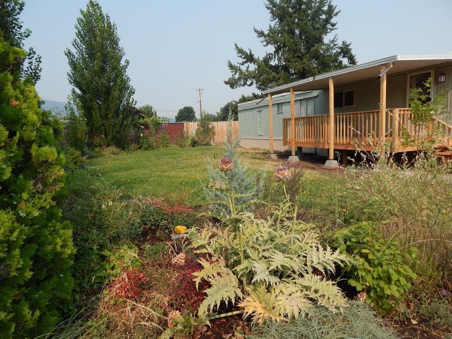 Come home to the quiet life at Candlewood, a 55+ park in Talent. Located at the end of the park, this 2 bedroom, 1 bath single wide is a lot of home for a little price tag. The home has a new front porch overlooking a nice big yard where you can enjoy time outdoors. Irrigation water is free so you can keep your grass green! A small ceiling vault gives the living room a feeling of more space than you would expect. A soft, green palate reflects a peaceful and bright atmosphere. This home has been updated with new laminate floors, new sink & cabinets in the kitchen, a new water heater, new tub & shower, new windows, new skirting all around the home, new back steps, new HVAC in 2012, a newer roof and has been re-leveled. There are still a few more projects for you to complete. There are 3 storage sheds for the gardener or tinkerer. Imagine sipping lemonade on the front porch while the leaves turn color on the hills behind Talent this fall. Let us put up the sold sign for you.