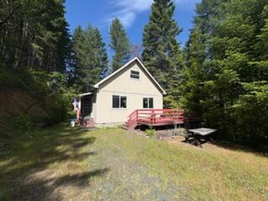 Escape from the city in this off grid 3/2 two story home with 1144 sq. ft. An on site propane tank provides energy for the on demand hot water heater. Water is provided via a spring fed well and uphill storage tank. There is a functioning septic system in place.  Nestled within the quiet forest consisting of Douglas fir, mature oaks and madrones, on the acreage of two lots totaling 8.92 acres of land. Used originally as a mining spot this off the beaten path home would be a great cabin retreat in the summer or vacation get away. There is a year round creek and several ponds. Abundant ferns line the driveway in and the property lays just a mile or so up the street from historic golden Oregon a ''Gunsmoke filming location''. Maintained driveway is just a couple tenths of a mile from the main road (Coyote creek rd.) Only 20 minutes from downtown Grants Pass.