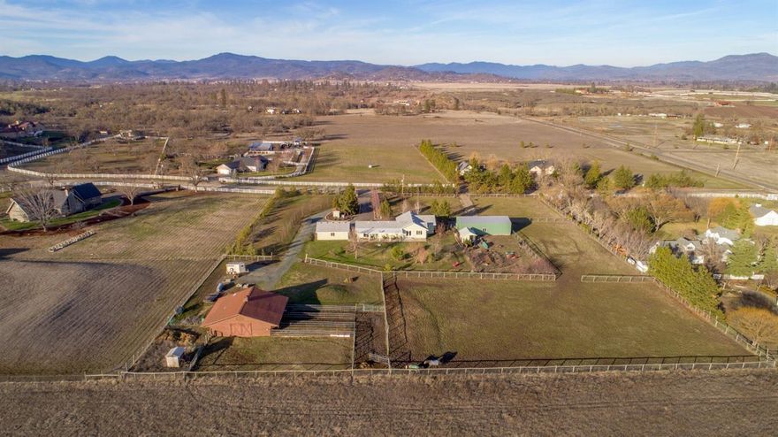 NEW PRICE! Such a rare find! Updated home, brand new shop plus a 3 stall barn; all on 3.69 acres just 1/2 mile from Kriselle Cellars, 5 mins from fishing and rafting on the Rogue River or hiking the Table Rocks, yet conveniently located with quick and easy access to Medford and surrounding communities. Opportunities like this don't come often! The updated home offers a custom kitchen with large island, granite counters and abundant storage; a spacious master suite with custom bath and walk-in closet; separate living/family rooms; solid surface floors throughout and ample natural light. The outdoor extras are extensive with an oversize 2 car garage; 28' x 54' shop with 12' ceiling and 200 amp service; 3 stall barn with tack room, hay loft, power and water; fenced and cross fenced pastures; chicken coop; garden area with shed; gated entry and circular drive. Relax and enjoy it all while you take in the beautiful southern views from your spacious covered patio. This is the total package!
