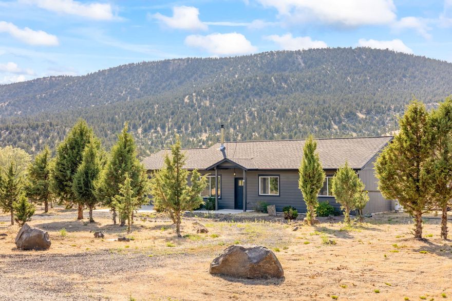Welcome to your Central Oregon getaway! Nestled just minutes from Prineville Reservoir, this adorable 2018-built home offers 3 bedrooms, 2 full baths and an inviting open-concept layout with vaulted ceilings that create a light and airy feel throughout. Situated on 1.24 acres of usable land that was recently fenced, the property features full RV hookups, ideal for guests or extended stay, and is connected to community water for convenience. Watch the Golden Eagles soar above the unique rock croppings and picturesque terrain. Whether you are looking for a full-time residence, weekend escape or vacation rental opportunity, this home offers peaceful living with easy access to outdoor adventures like boating, fishing and hiking. Just a short drive to downtown Prineville, yet far enough to feel like your own private retreat.