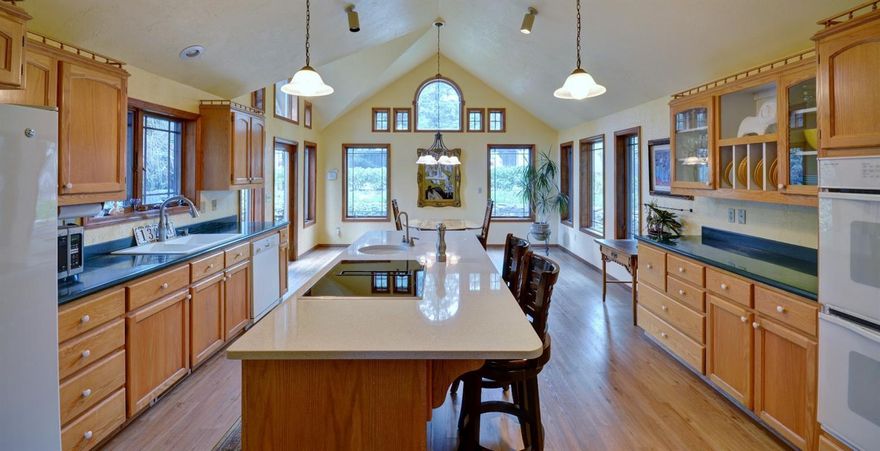 Wonderful home with Rogue River frontage.The possibilities are endless here. It would be a lovely bed and breakfast or air BNB with a separate master with own entrance. Gated entry, paved driveway and plenty of parking for guests or family. This is the perfect property for someone that loves to garden and play in the dirt. The kitchen is the heart of the home with large island with new granite, new flooring, dbl ovens, dbl sinks, plenty of counter tops and storage. Gorgeous hardwood floors, large windows, skylights, French doors, vaulted ceilings, crown molding, archways and columns make this a special place to call home. 4 large bedrooms and 3 full baths with casual and formal rooms. Incredible views from just about every spot in the house yet very private. Entertain off the back decks or down on your private beach with access to the river. Bring your imagination and make your dreams a reality.