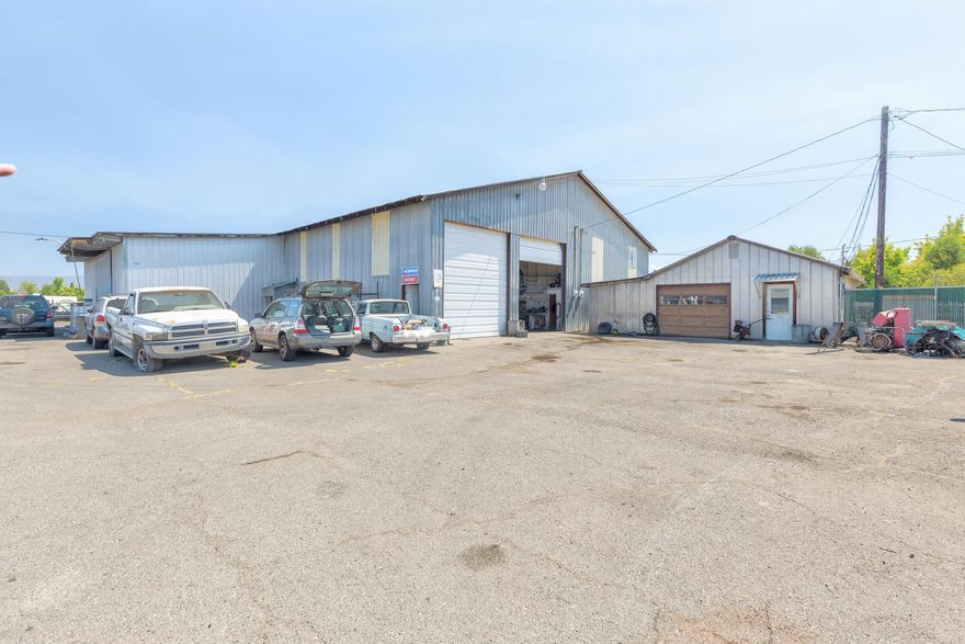 Active Automotive mechanical business with 1.44 acres of land as well as up to 9 rentable shops, with 7,000 sq feet of shop space, and a currently rented Mobil home for income rental. 3 restrooms on property. Many uses or run your own business turn key!